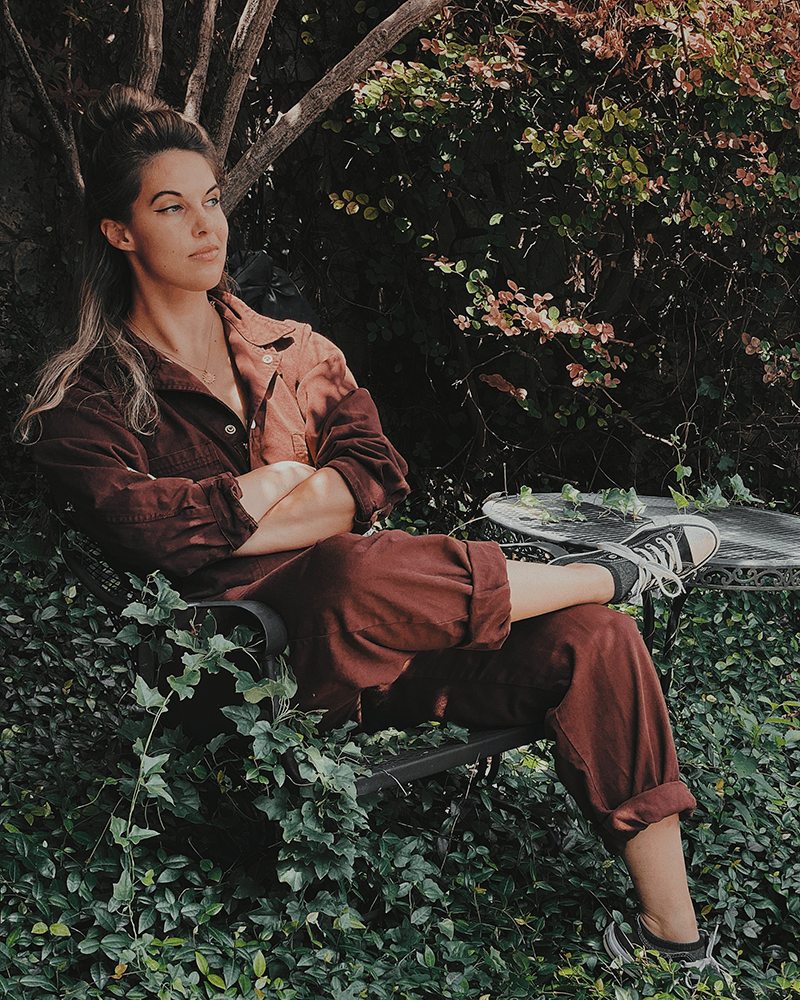 A portrait of myself sitting in a chair surrounded by ivy for fun